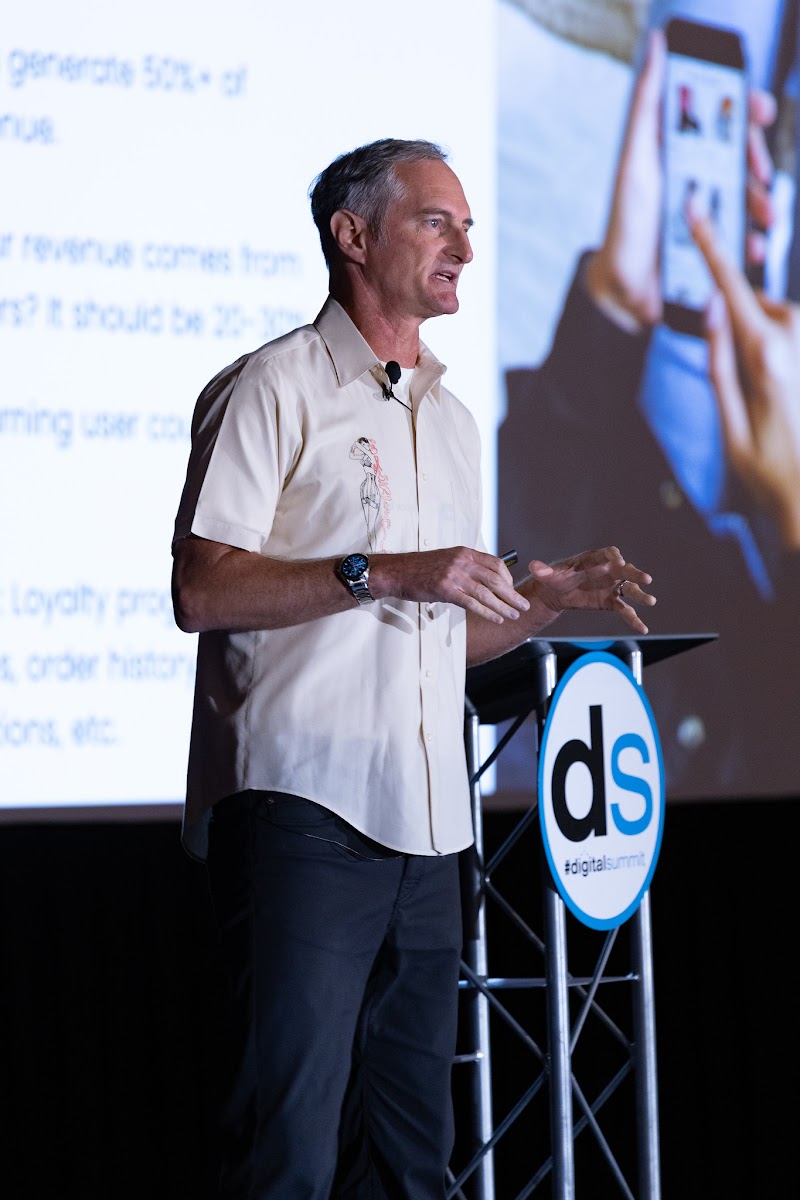 Kent Lewis addressing an audience at an industry event